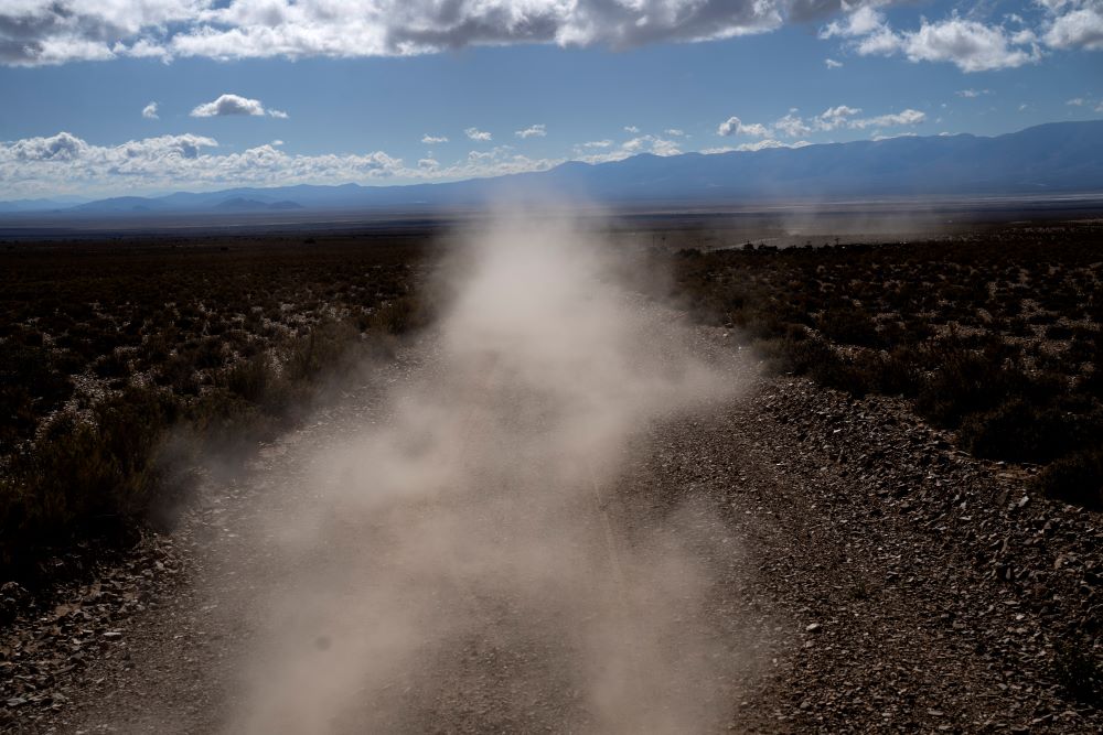 Dust is kicked up from the road as the de Callata family drives to the site where they raise livestock in Tusaquillas, Jujuy Province, Argentina, on April 23, 2023.
